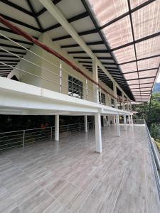 a large building with white columns and a roof at El desmadre villa lujosa Florencia, Caqueta in Florencia