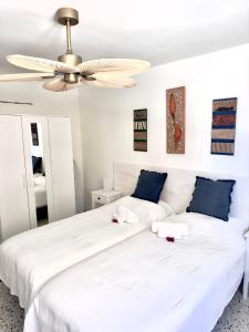 a bedroom with two beds and a ceiling fan at AGUA MARINA in Candelaria