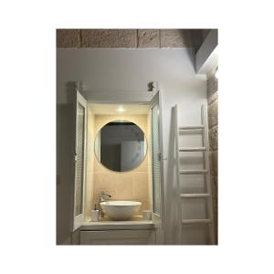 a bathroom with a sink and a mirror at Locus Amoenus in Polignano a Mare