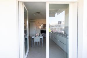a kitchen with a counter and a table in it at Seventyfive House in Chioggia +4 photos