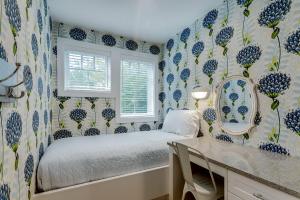 a bedroom with a bed with blue and white wallpaper at Lakemore Resort in Traverse City