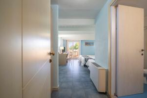 a hallway leading to a room with a bedroom at Cala Della Torre Resort in La Caletta