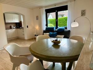 a living room with a table and chairs and a kitchen at Schöne Wohnung mit großem Garten in Stockach