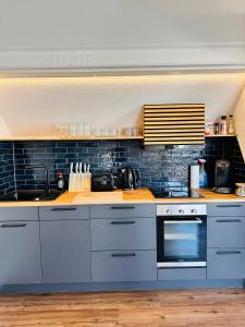 a kitchen with white cabinets and a stove at Villa Dana Bodensee in Friedrichshafen