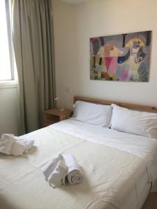 a bedroom with a bed with towels on it at Ne parliamo Stasera in Porto Santo Stefano