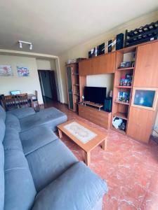 a living room with a couch and a table at Completa y Amplia Habitación a 10 minutos de la playa Casa Compartida in Algaida