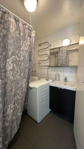 a bathroom with a sink and a shower curtain at Superhomes 1 gäst in Gothenburg