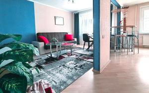 a living room with a couch and a table at EMVIKA apartament in Šiauliai