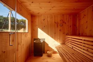 a wooden room with a sauna with a window at Le Domaine de Bra in Bra