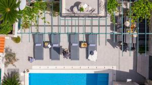 an overhead view of a swimming pool in a building at Villa Filipetti in Makarska center, 4 en-suite bedrooms charming stone house, heated private pool, 600m from beach in Makarska