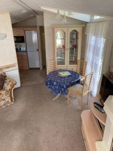 a room with a table and chairs and a kitchen at Caravan 131 in Norwich