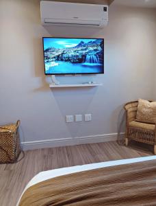 a room with a flat screen tv on a wall at Apartment at Hermanus Waterfront in Hermanus