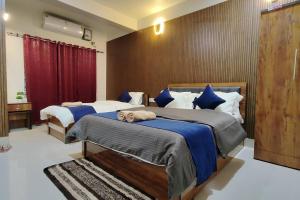 a bedroom with two beds with blue sheets at D2Stay Homestay 2Bhk for 5person Near Paltan Bazar in Guwahati
