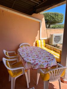 a table and chairs in a room with a table and a couch at Casa azzurra Salina Bamba in Punta Molara +22 photos