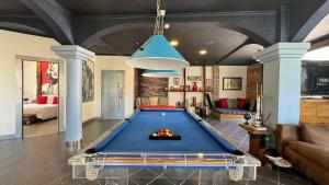 a living room with a pool table in it at The Modern & Recycled House in Machico