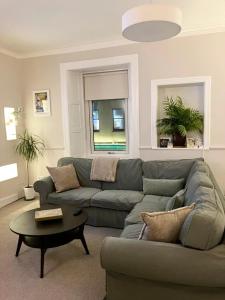 a living room with a couch and a table at The Wheelhouse, Gourock in Gourock