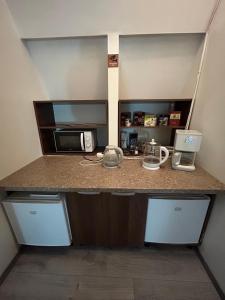 a kitchen with a counter top with a microwave at Casa Romana in Bucharest