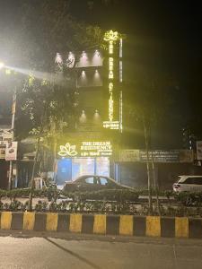 a car parked in front of a building at night at New Dream Residency By Glitz Hotels in Mumbai