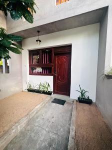 a wooden door on the side of a building at Sera 86 Airport Transit Stay in Katunayake