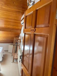 a wooden door in a room with a staircase at Bedesten Pansiyon in Çeşme +41 photos