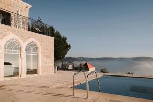 a house with a swimming pool next to a building at Beit Teta Mona in Al ‘Arabah