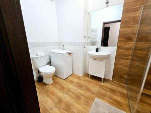 a bathroom with a toilet and a sink at FIRST -- Green Żoliborz apartment 3 in Warsaw
