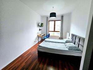 una camera con letto, scrivania e finestra di FIRST -- Green Żoliborz apartment 3 a Varsavia