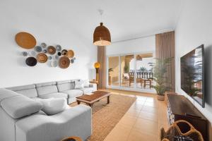 a living room with a couch and a table at Marina Views Al Hamra Village in Ras al Khaimah