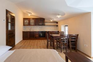 a kitchen and dining room with a table and chairs at Guest House Valentincic in Nova Gorica