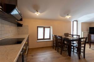 a kitchen and dining room with a table and chairs at Guest House Valentincic in Nova Gorica