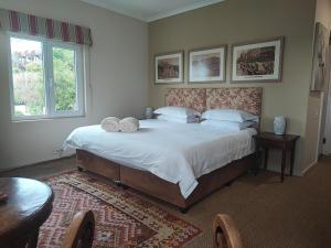 a bedroom with a large bed with two pillows on it at Rosedene Guest House in Cape Town +34 photos
