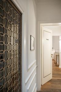 a hallway with a door with a patterned wall at Parisii Luxury Relais Rome in Rome