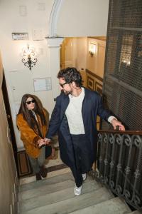 a man and a woman walking down a staircase at Parisii Luxury Relais Rome in Rome