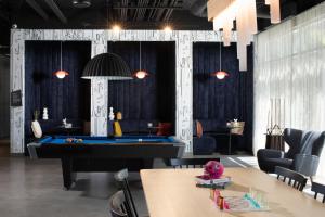 a billiard room with a pool table in the middle at Aloft McAllen in McAllen