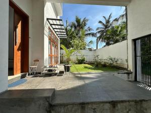 an external view of a house with a patio at Beauty World Villa - Gampaha in Gampaha
