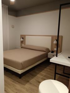 Postel nebo postele na pokoji v ubytování Hotel Columbia & Ninfea