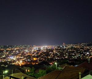 a view of a city lit up at night at " Relax & Enjoy " in Sarajevo