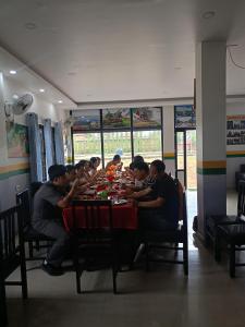 a group of people sitting at a table eating at Hotel Kanthak in Lumbini