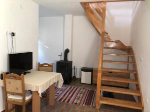 a room with a staircase and a desk with a television at Vikendice - Vodenica Jurić in Prozor