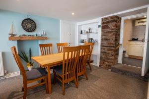 a dining room with a wooden table and chairs at Cottage in the Heart of Brixham in Brixham