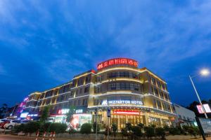 a building with a sign on top of it at MIZPARTON HOTEL - Heshan New Town in Jiangmen