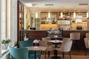 a restaurant with tables and chairs and a bar at Klebelsberg Kast&eacute;ly Budapest in Budapest