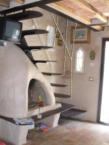 een pizza-oven met een tv erop bij Gemütliches Landhaus in ruhiger Lage mit herrlicher Pergola und Blick bis zur Küste in Montigiano
