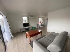 a living room with a couch and a table at Aberdeen home stay in Gisborne