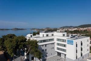 an apartment building with a view of a body of water at SeeSea Hotel in Vodice