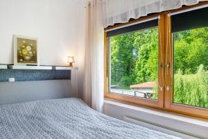 a bedroom with a bed and a large window at Ferienwohnung Gabi in Malchow