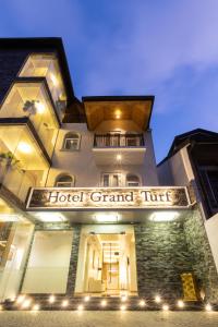 a hotel grand rift is lit up at night at Hotel Grand Turf By GSP in Nuwara Eliya