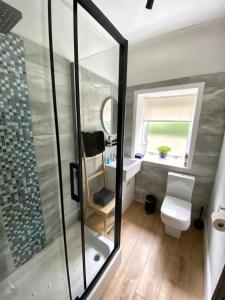 a bathroom with a shower and a toilet and a sink at The Wheelhouse, Gourock in Gourock