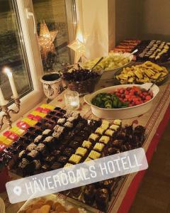 a buffet of different types of food on a table at Häverödals hotell in Hallstavik
