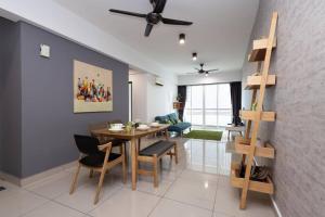 a dining room and living room with a table and chairs at Dream - Summer @Majestic Condo in Ipoh